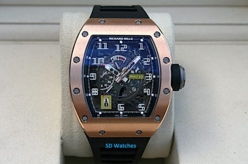 Richard Mille RM30 | SD Watches SkeletonRichard Mille watch with a rose-gold bezel, black strap, and exposed gears visible through a blue-tinted dial.