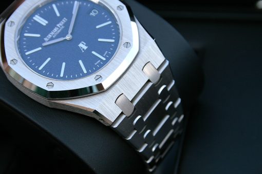 IMG_6357 | SD Watches Close-up of a stainless steel luxury wristwatch with a blue dial and visible screws on the bezel and bracelet links.