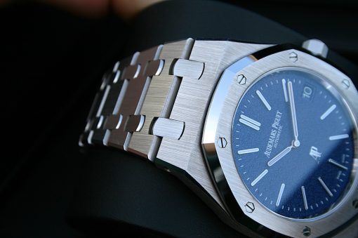 IMG_6358 | SD Watches Close-up of a stainless steel luxury wristwatch with a blue dial and brushed bracelet links showing screws on the bezel at an angle