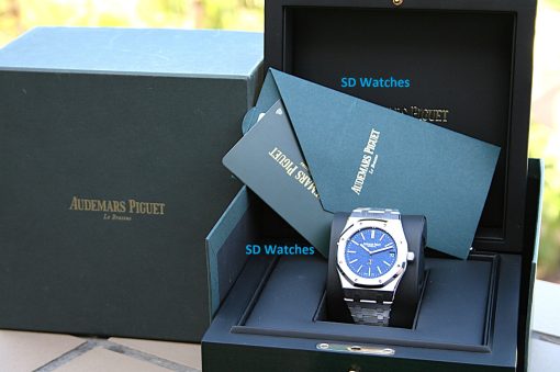 IMG_6362 | SD Watches Audemars Piguet wristwatch with a blue dial in a black display case with blue presentation cards labeled SD Watches in the background.