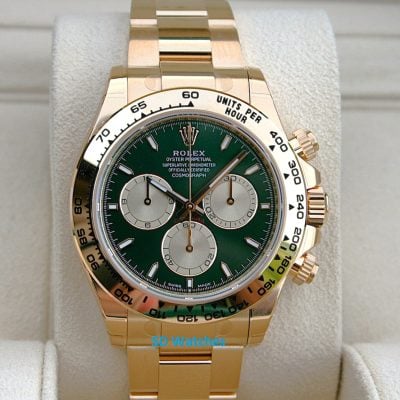 Rolex 126508 John Mayer | SD Watches Gold Rolex chronograph watch with a green dial on a padded display cushion, close-up view