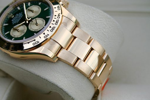 IMG_6519 | SD Watches Close-up of a gold wristwatch with a green dial and three subdials on a cushioned surface