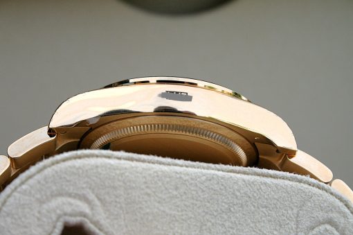 IMG_6521 | SD Watches Close-up of a rose-gold wristwatch with its back casing exposed, resting on a soft gray towel.
