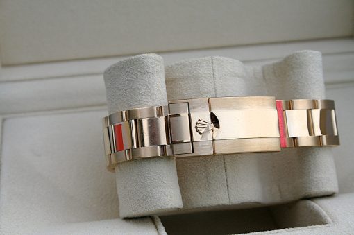 IMG_6523 | SD Watches Close-up of a stainless steel watch bracelet wrapped around a soft, light-gray display cushion in a jewelry setting.
