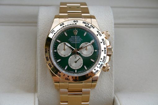 IMG_6531 | SD Watches Gold Rolex Oyster Perpetual Cosmograph Daytona with green dial on a padded display cushion.