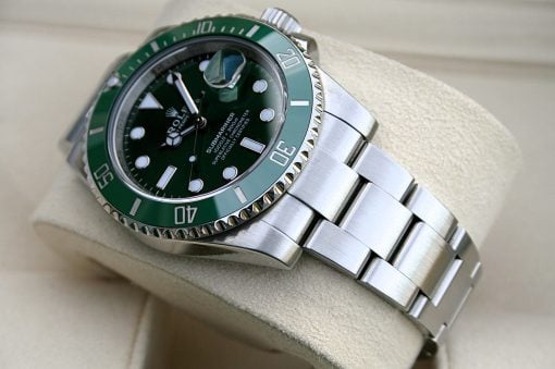 IMG_6543 | SD Watches Green-bezel Rolex Submariner stainless steel watch on a beige cushion, close-up detail of the face and bracelet