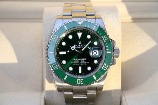 IMG_6560 | SD Watches Rolex Submariner with a green bezel and dark green dial, stainless steel band, displayed on a light cushion.