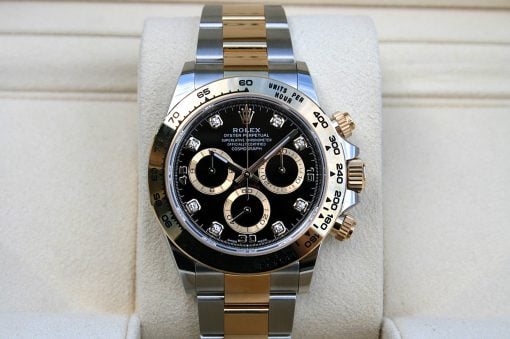 IMG_6690 | SD Watches Rolex Daytona chronograph with black dial, diamond hour markers, and two-tone gold and steel bracelet on a display cushion.
