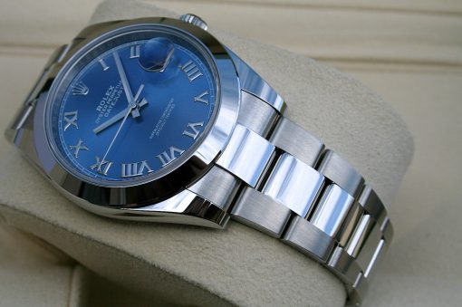 IMG_6697 | SD Watches Blue dial Rolex Oyster Perpetual Datejust with Roman numerals on a stainless steel bracelet, tilted on a beige surface.