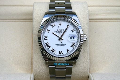 Rolex 126334 | SD Watches Rolex Datejust wristwatch with a white dial, Roman numerals, and a fluted bezel displayed on a beige cushion.
