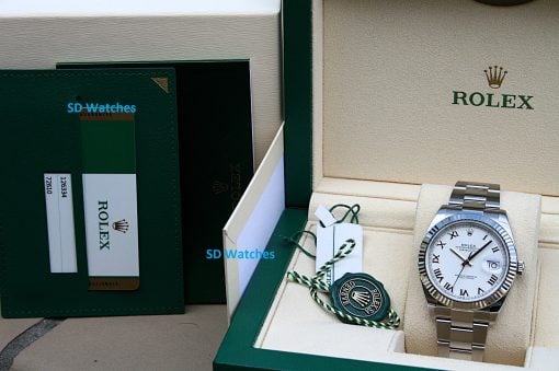 IMG_6722 | SD Watches Rolex watch in an open beige presentation box with green outer packaging and attached green-and-white tags