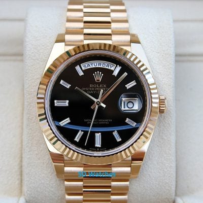 Rolex 228238 | SD Watches Gold Rolex Day-Date watch with black dial, diamond markers, and day/date windows.