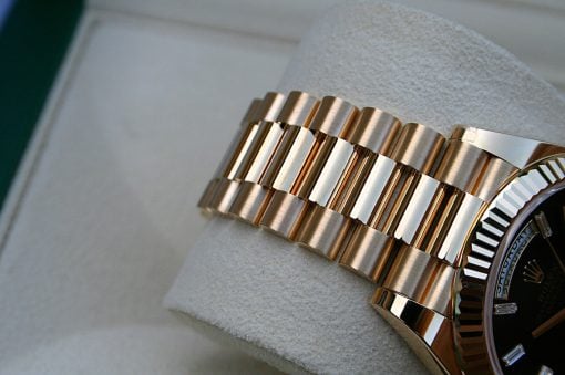 IMG_6733 | SD Watches Close-up of a gold metal watch bracelet and part of the bezel/dial on a light surface.