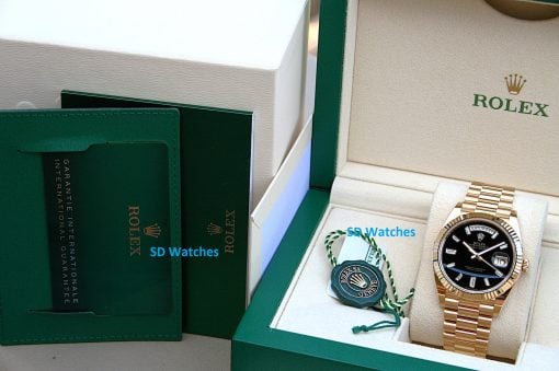 IMG_6742 | SD Watches Rolex gold watch in an open beige box with green outer packaging and accompanying green cards and tags
