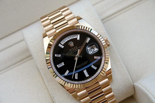 IMG_6743 | SD Watches Gold Rolex Oyster Perpetual Day-Date watch with black dial and diamond hour markers on a textured beige surface