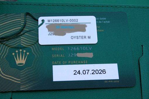 IMG_6787 | SD Watches Close-up of a Rolex warranty card on a green surface, showing the model 126610LV and a date of purchase 24.07.2026, with a blue 'SD Watches' label over part of the card and the Rolex crown logo visible nearby.