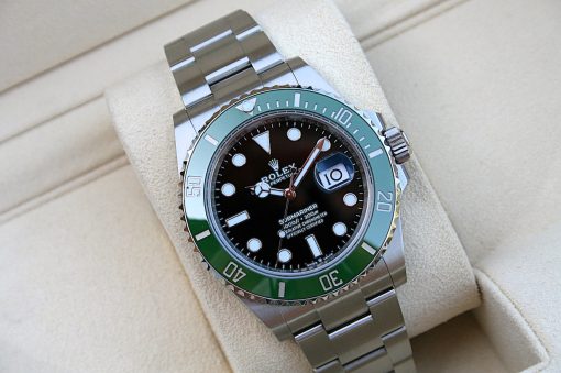 IMG_6789 | SD Watches Stainless Rolex Submariner watch with black dial and green bezel on a beige cushion