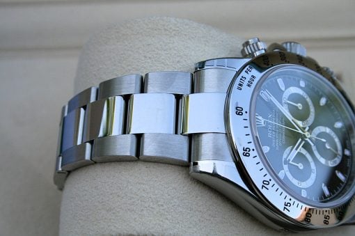 IMG_6824 | SD Watches Close-up of a stainless steel wristwatch with a tachymeter bezel resting on a textured surface.