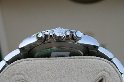 IMG_6826 | SD Watches Close-up of a stainless steel watch crown and two pushers on the side of the case, resting on beige fabric.
