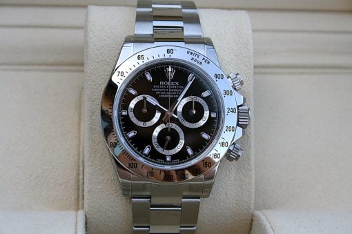 IMG_6837 | SD Watches Rolex stainless steel chronograph watch with black dial and silver subdials on a beige cushion display.