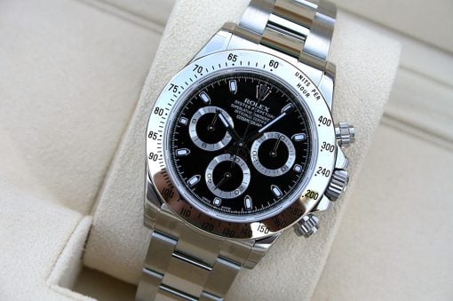 IMG_6839 | SD Watches Close-up of a stainless steel Rolex Daytona watch with a black dial and silver subdials in a beige display case.