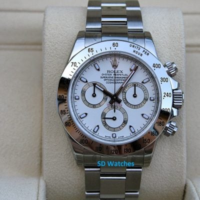 Rolex Daytona watch with white dial and silver tachymeter bezel on a beige display stand