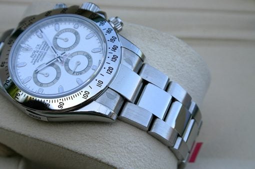IMG_6846 | SD Watches Stainless steel wristwatch with a white dial and multiple subdials, resting on a beige cushion; rotating bezel with black numbers visible at the edge.