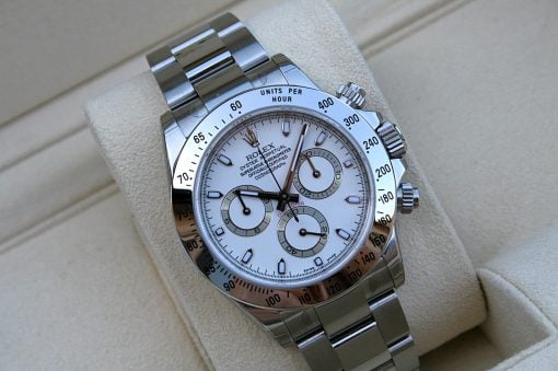 IMG_6858 | SD Watches Close-up of a stainless steel Rolex chronograph watch resting on a beige cushion.