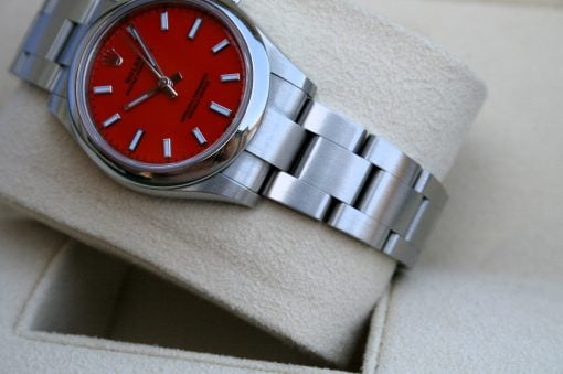 IMG_6758 | SD Watches Rolex Oyster Perpetual watch with a red dial and stainless steel bracelet resting in a beige display box.