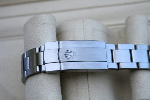 IMG_6760 | SD Watches Close-up of a silver metal Rolex watch bracelet clasp with the crown logo in the center.