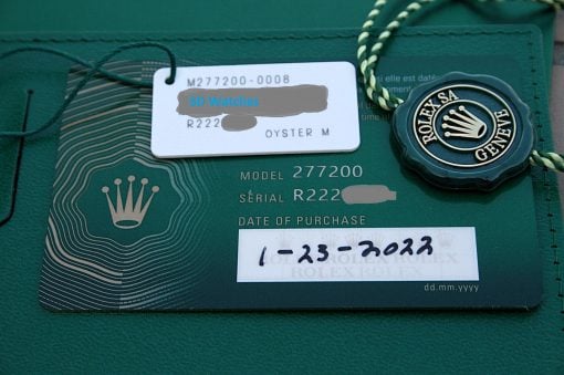IMG_6769 | SD Watches Green Rolex box with a white tag reading SD Watches and a Rolex crown seal on a green surface.