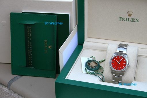 IMG_6770 | SD Watches Rolex watch with red dial in an open green presentation box with certificate seal and tag nearby