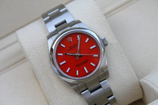 IMG_6771 | SD Watches Rolex Oyster Perpetual watch with a bright red dial and silver stainless steel bracelet on a beige cushion.