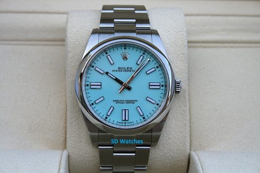 Rolex 124300 Tiffany Blue | SD Watches Rolex Oyster Perpetual watch with a turquoise dial on a beige display cushion, stainless steel bracelet visible.
