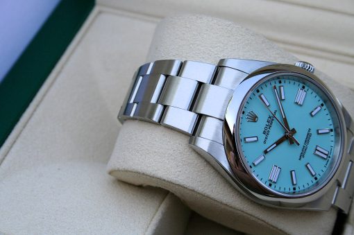 IMG_6801 | SD Watches Luxury stainless-steel Rolex watch with a turquoise dial resting on a light cushion.