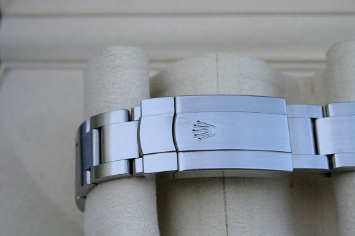IMG_6802 | SD Watches Close-up of a silver Rolex watch bracelet clasp with the crown logo engraved on it.