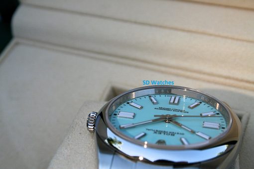 IMG_6809 | SD Watches Close-up of a turquoise dial wristwatch with a silver case resting on a beige surface; the blue 'SD Watches' logo is visible on the image.