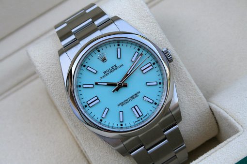 IMG_6814 | SD Watches Rolex Oyster Perpetual watch with a turquoise dial and stainless steel bracelet on a beige cushion.