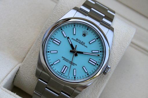 IMG_6819 | SD Watches Rolex Oyster Perpetual wristwatch with a turquoise dial on a metal bracelet resting on a beige display cushion