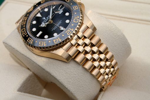 IMG_6893 | SD Watches Gold Rolex wristwatch with black dial and gold bezel, resting on a beige display cushion
