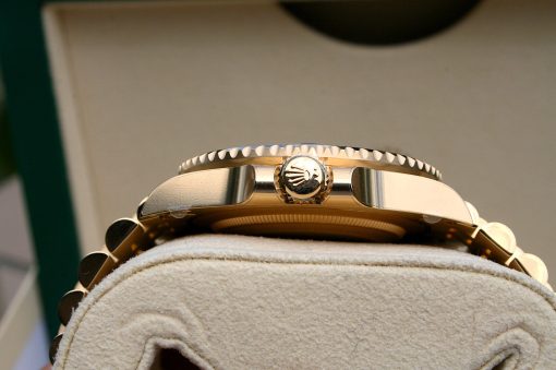 IMG_6897 | SD Watches Close-up of a gold Rolex watch crown and fluted bezel resting on a soft display cushion.
