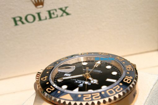 IMG_6899 | SD Watches Close-up of a Rolex watch with a blue-gold bezel, black dial, and magnified date window.