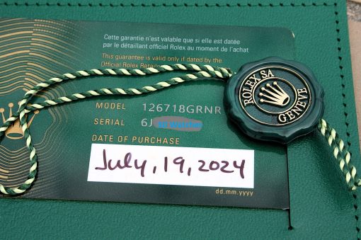 IMG_6901 | SD Watches Green Rolex warranty card with official seal, twisted green/cream string, and a handwritten date of July 19, 2024 on a textured green surface