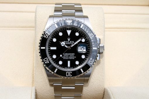 IMG_6923 | SD Watches Rolex Submariner stainless steel watch with black dial and date window on a beige display cushion