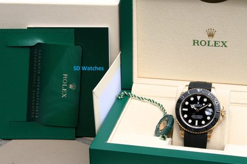 IMG_6939 | SD Watches Rolex watch in an open green box with beige interior and green accessories, showing a black dial and gold bezel.