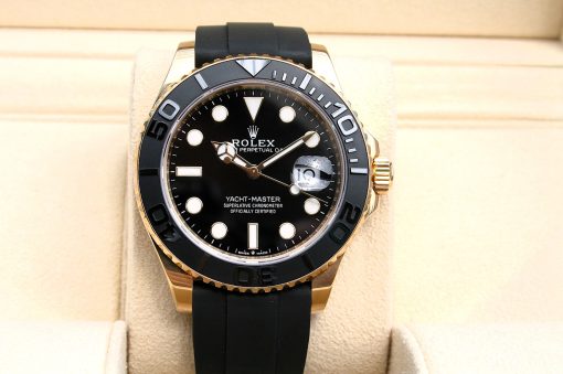 IMG_6941 | SD Watches Rolex Yacht-Master luxury watch with black dial, gold bezel, and black rubber strap on a beige display cushion.