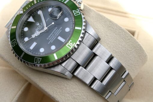 IMG_6947 | SD Watches Close-up of a Rolex Submariner watch with a green bezel on a beige surface