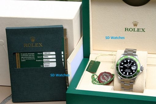 IMG_6952 | SD Watches Rolex watch with green bezel in an open beige display box, alongside warranty tags and a certificate booklet