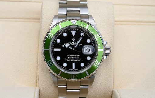 IMG_6956 | SD Watches Rolex Submariner stainless steel watch with a black dial and green bezel on a beige display cushion.
