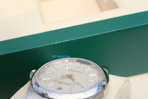 IMG_6974 | SD Watches Close-up of a silver wristwatch in a green display box with blue 'SD Watches' text in the background?